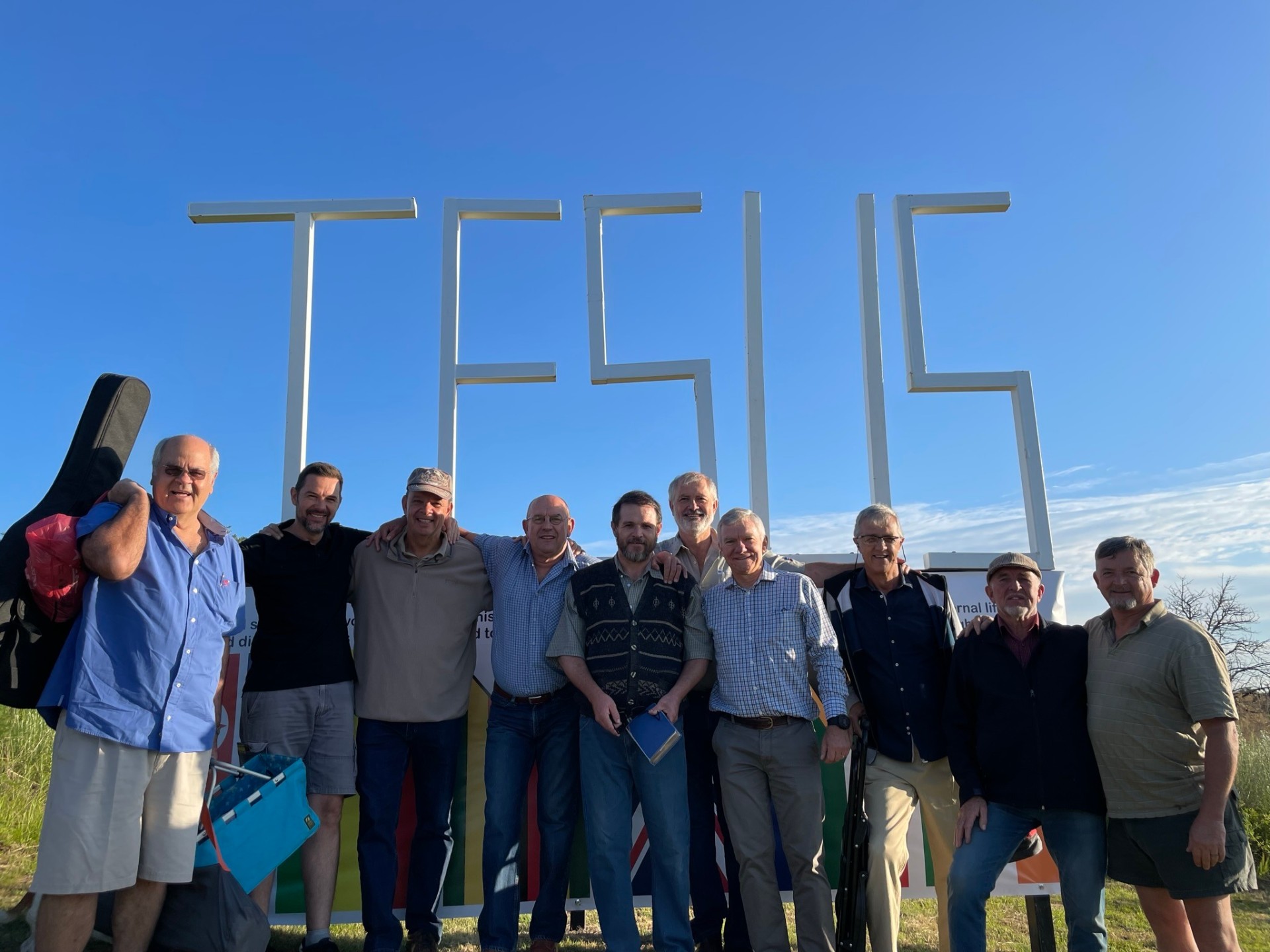 Men's group gathered at the JESUS sign