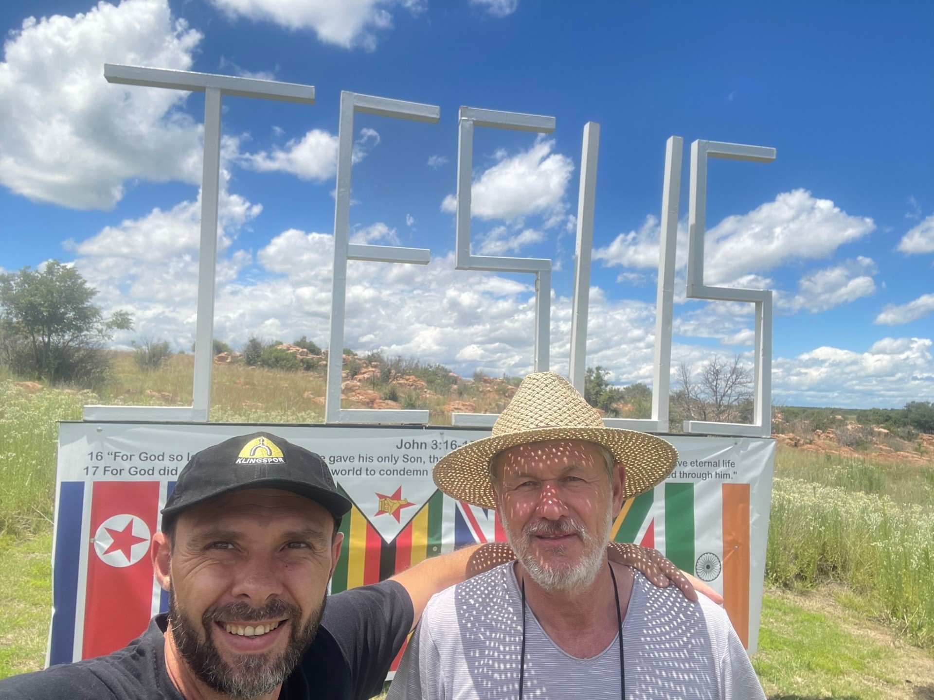 Father and son selfie at the JESUS sign
