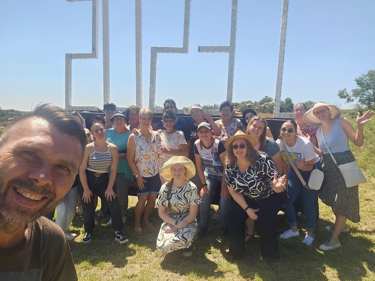 Joyful group selfie of ladies and friends at the JESUS sign