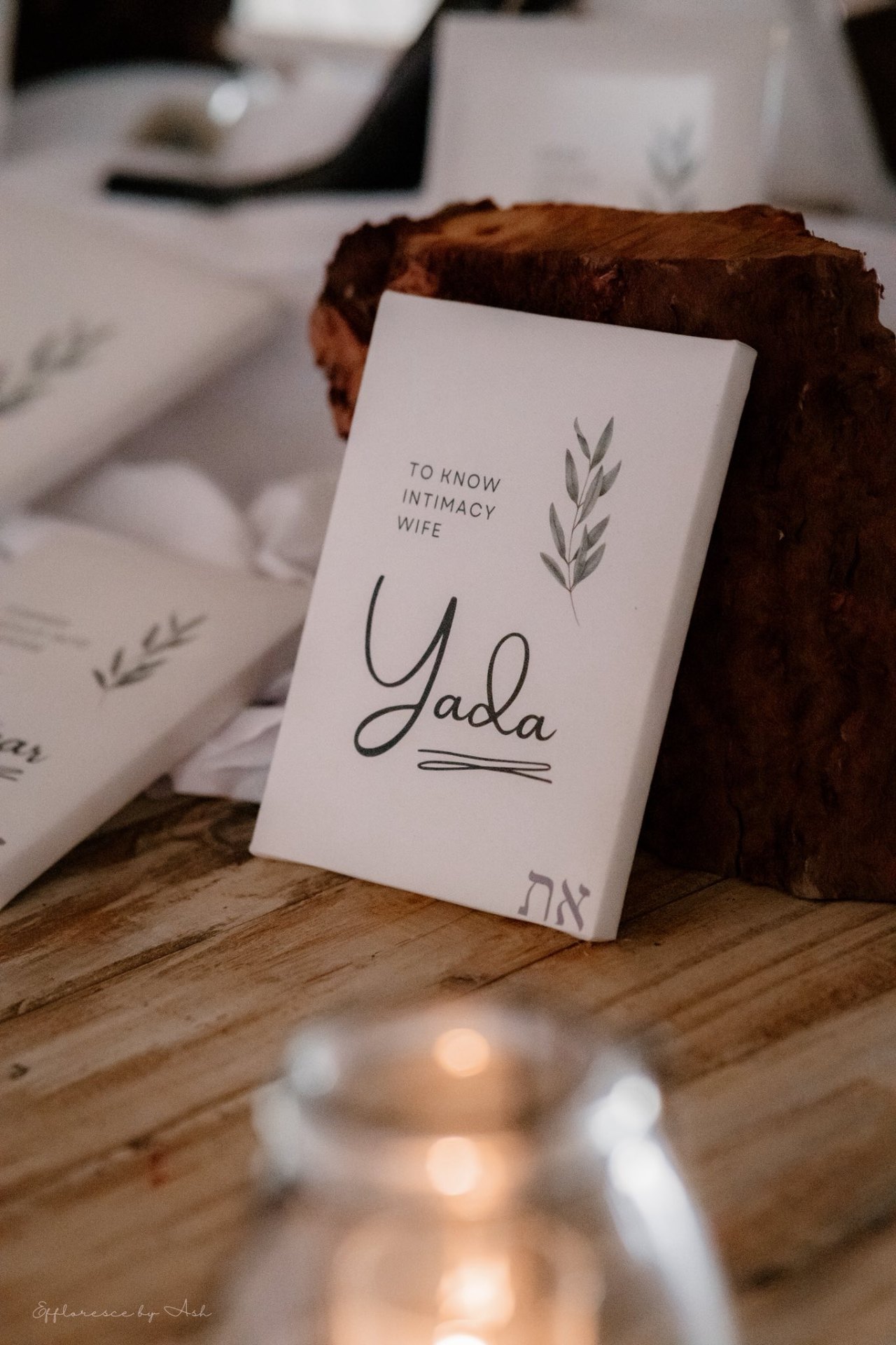 'Yada — to know intimacy' canvas card on a wooden table