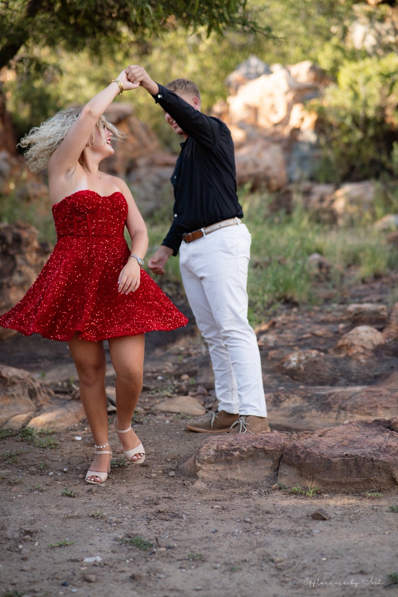 Couple dancing in matric farewell attire on the rocks